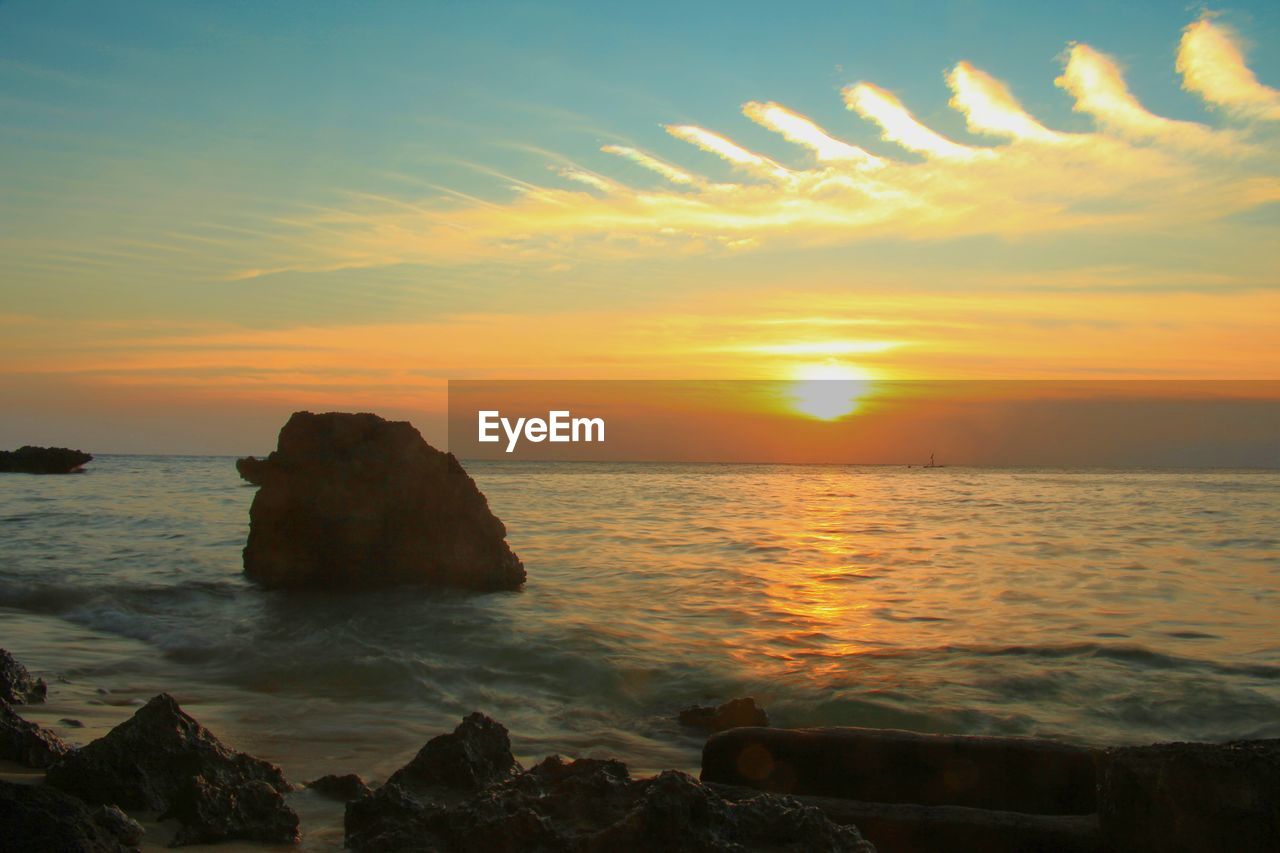 Scenic view of sea against orange sky