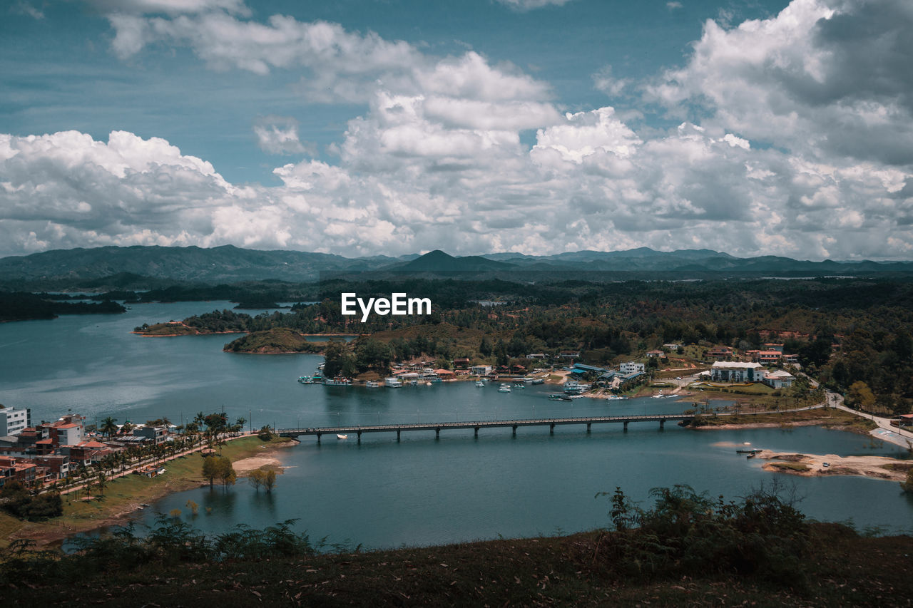 High angle view of lake by city against sky