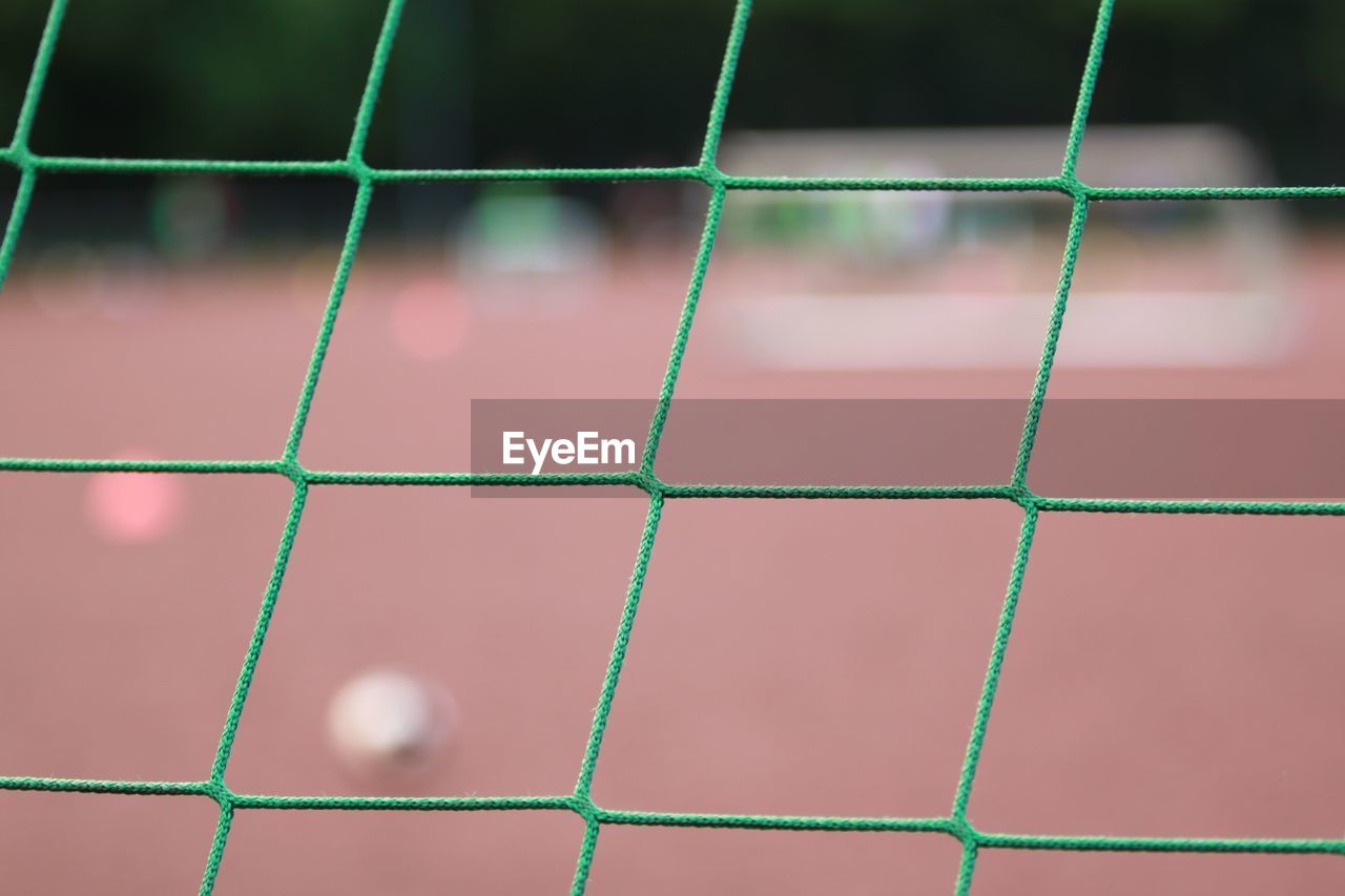 Close-up of soccer goal net on field
