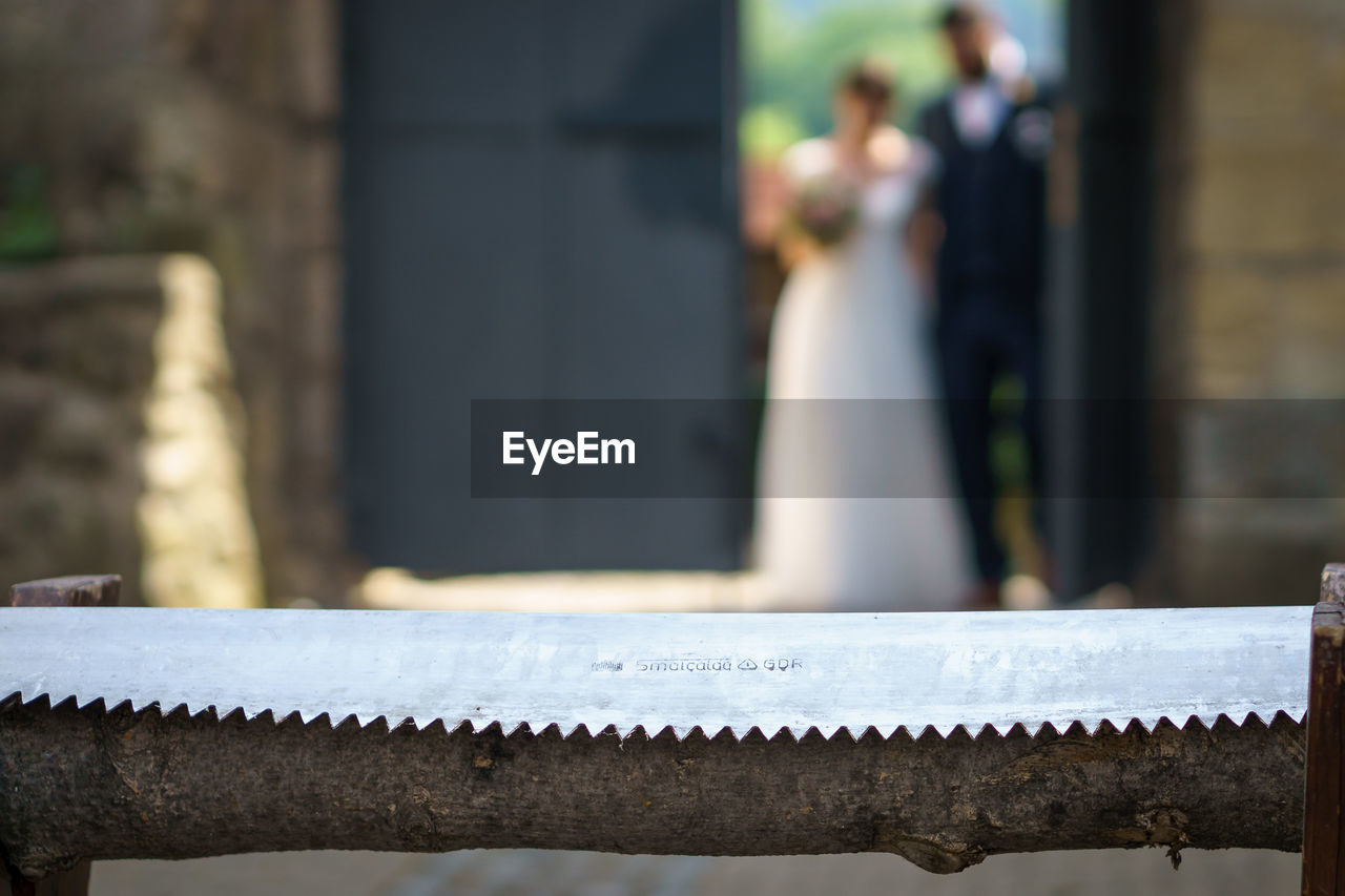 CLOSE-UP OF CHAIN ON RAILING BY BENCH