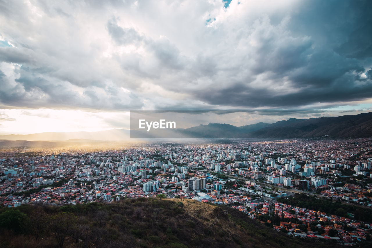 Areal view of cochabamba, bolivia with a cloudy sky and rays of sunlight. located in south america