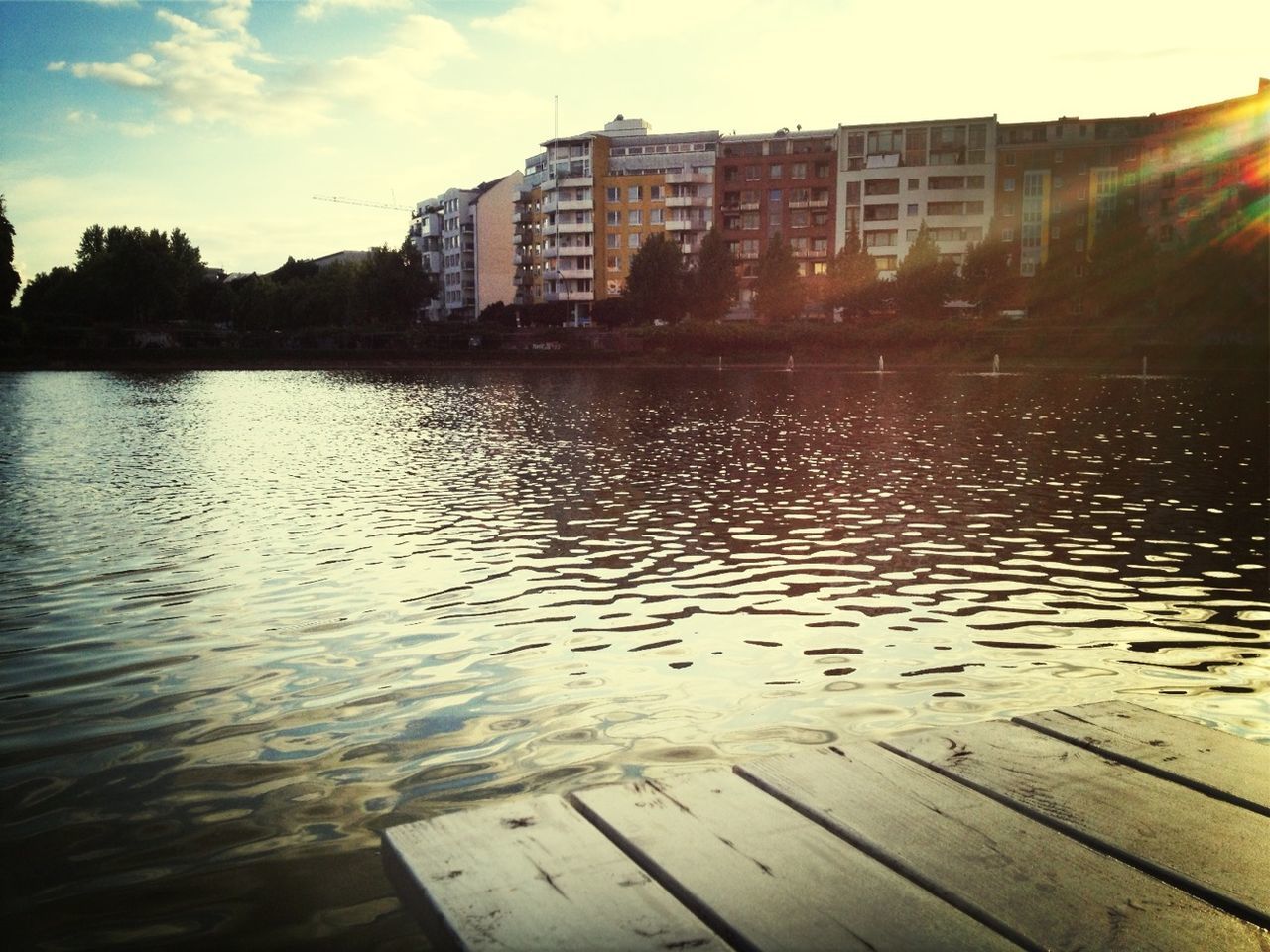 VIEW OF RIVER WITH BUILDINGS IN BACKGROUND