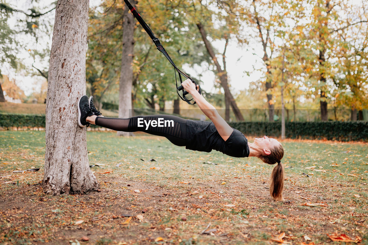 Full length of woman exercising in park