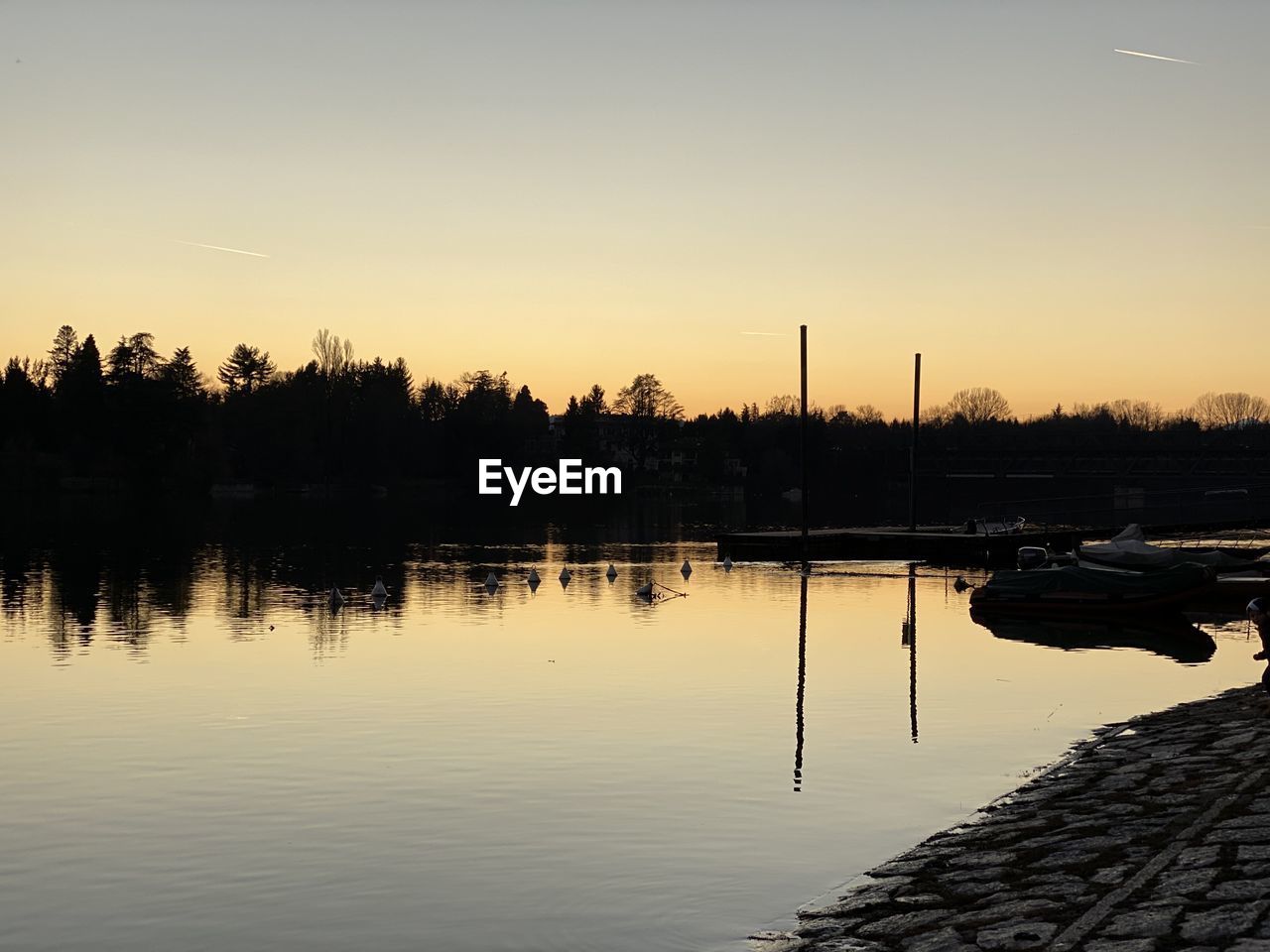 SCENIC VIEW OF LAKE AGAINST ORANGE SKY