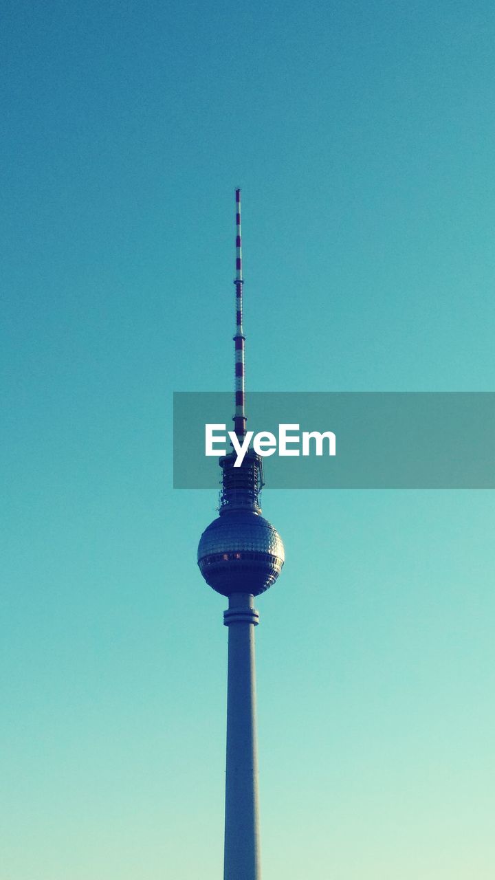 Low angle view of fernsehturm against clear blue sky