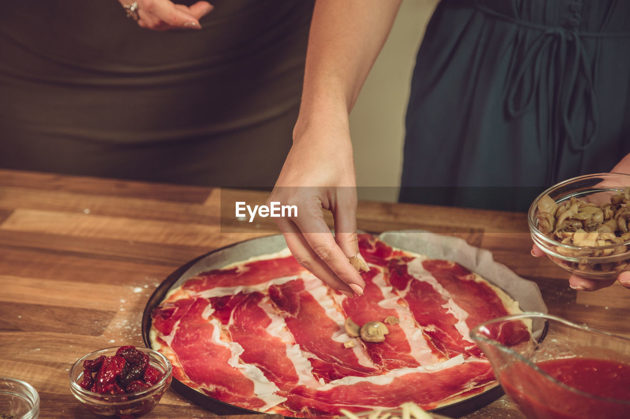 HIGH ANGLE VIEW OF WOMAN PREPARING FOOD