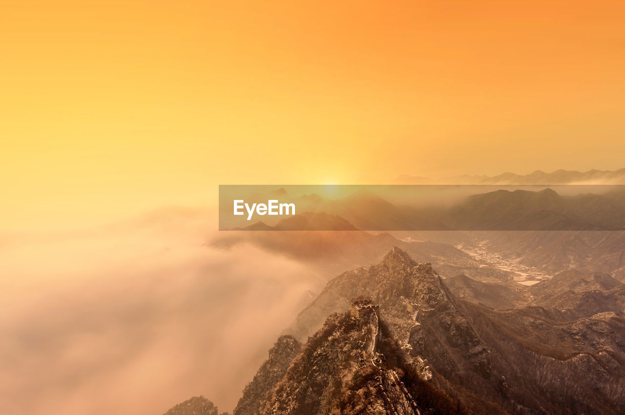 Scenic view of snowcapped mountains against sky during sunset