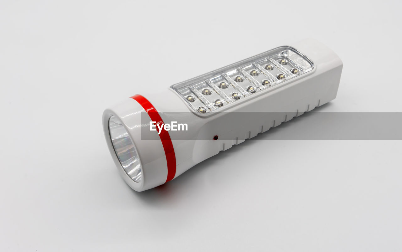 High angle view of flashlight against white background