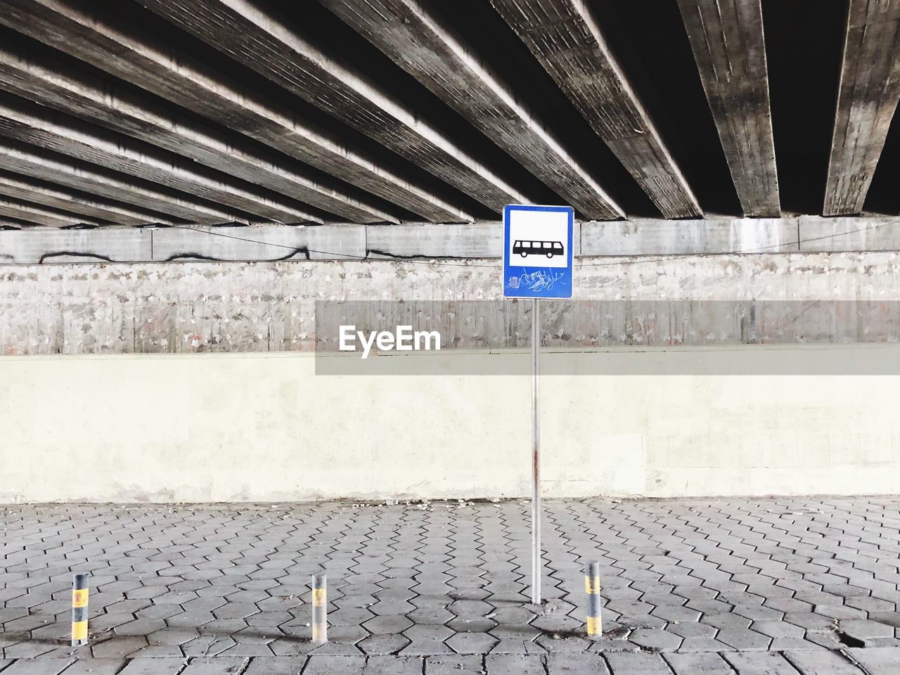 Bus stop under a bridge