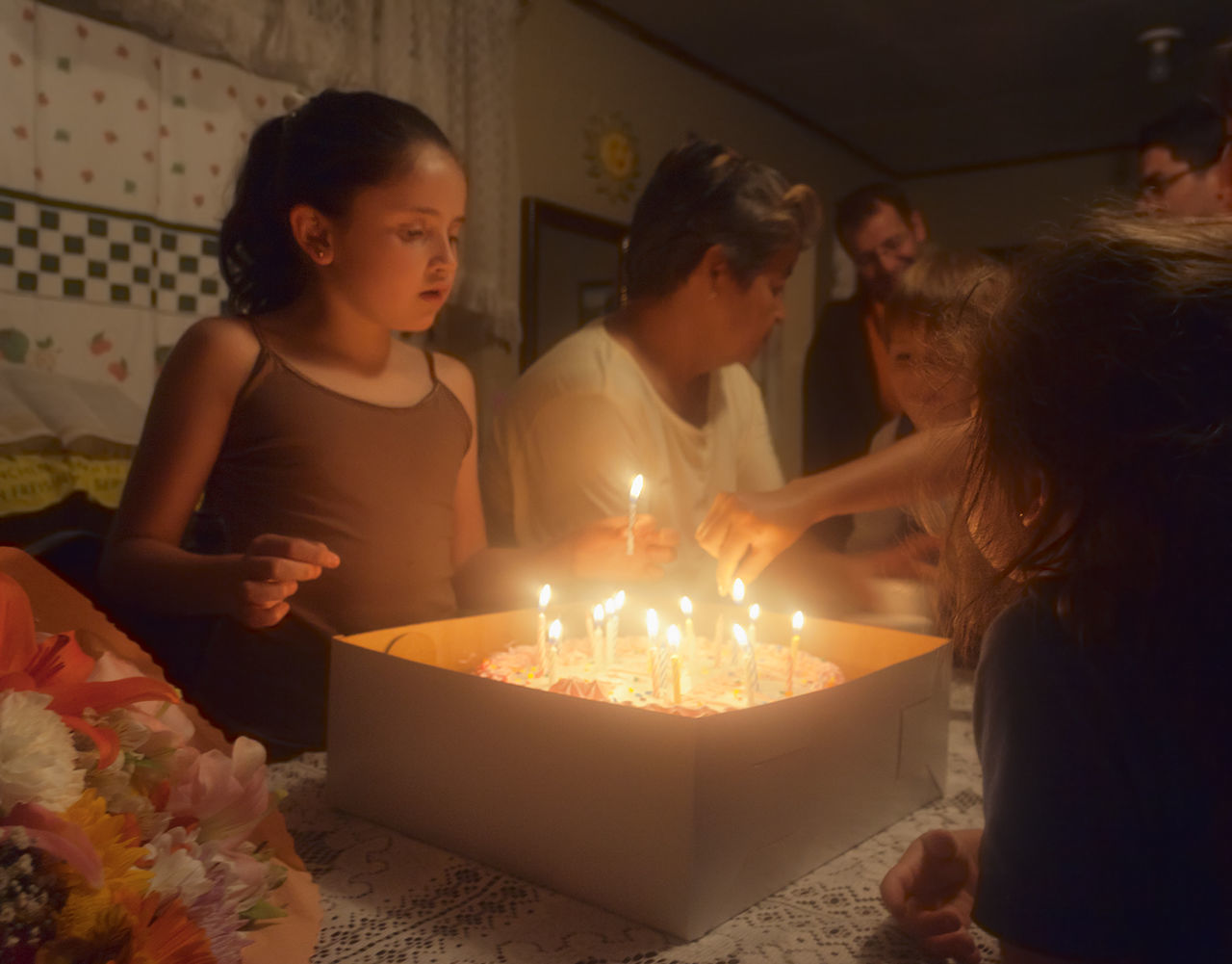 SIBLINGS IN ILLUMINATED ROOM