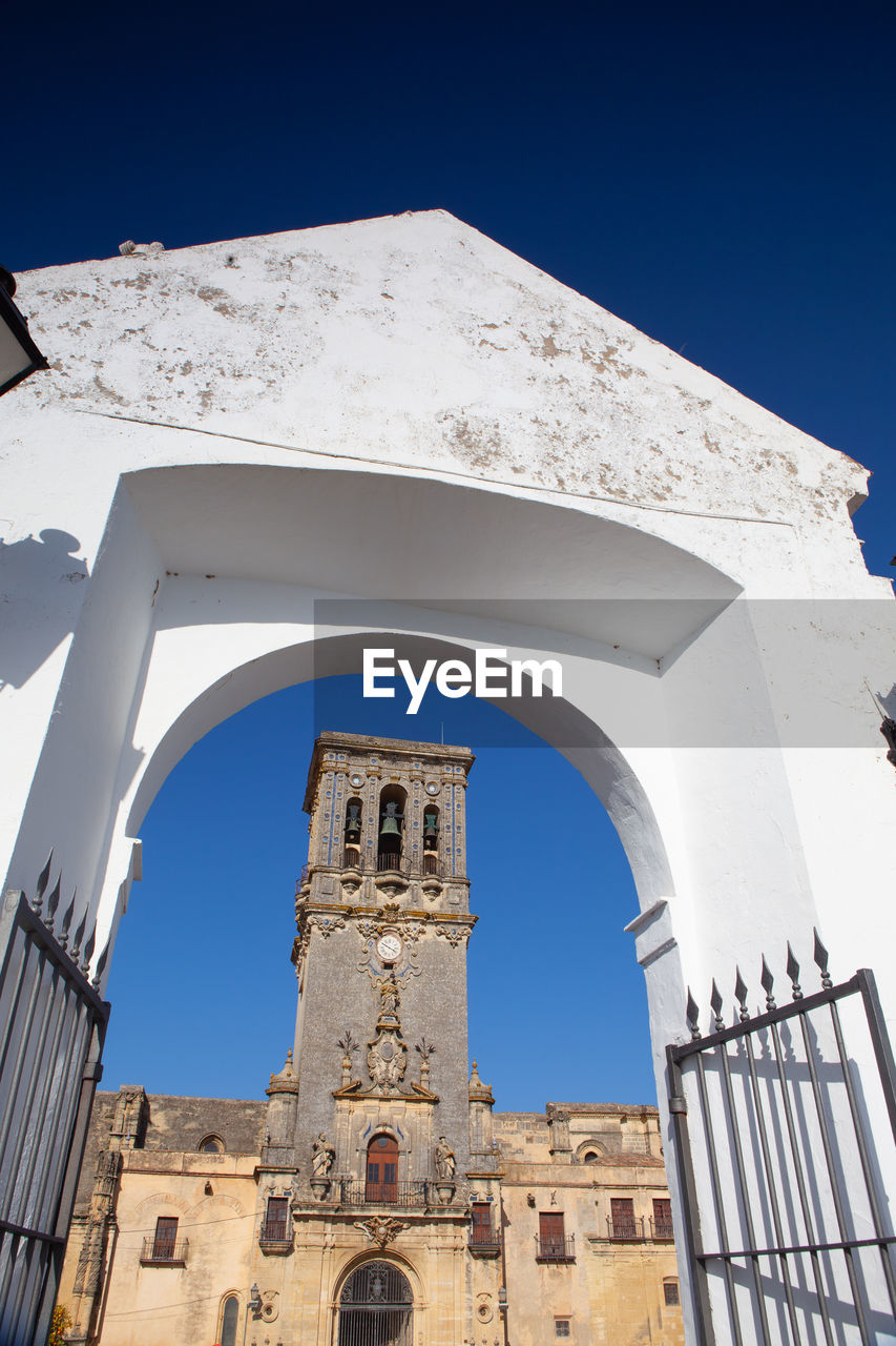 low angle view of old building against clear blue sky