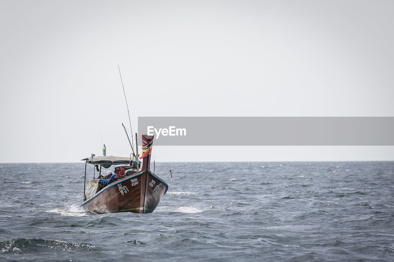 VIEW OF SAILBOAT IN SEA AGAINST CLEAR SKY