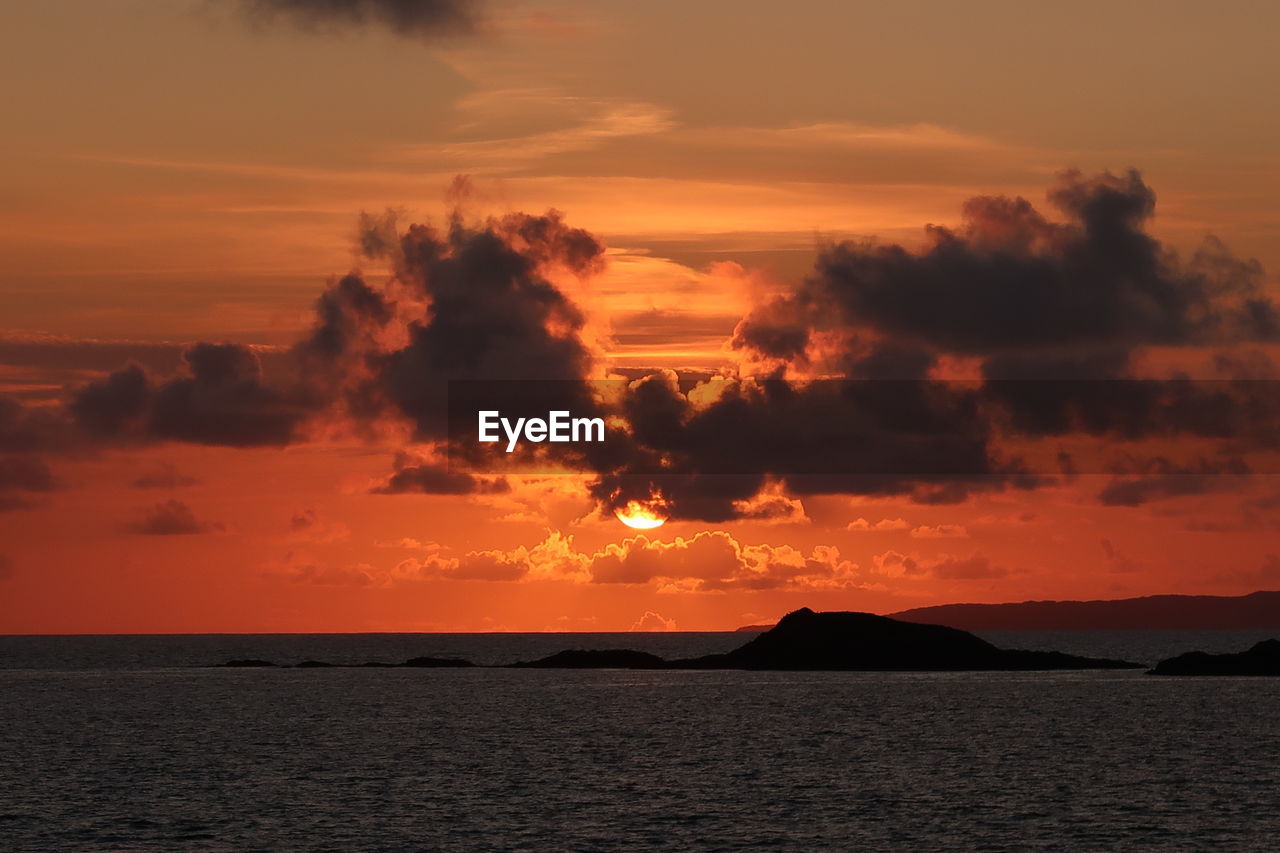 Scenic view of sea against romantic sky at sunset