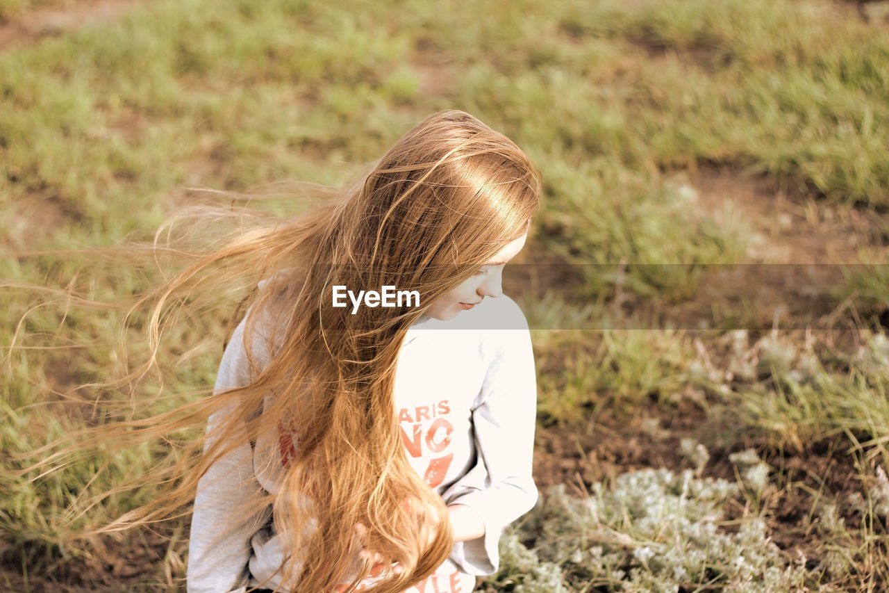 FULL LENGTH OF CHILD STANDING IN GRASS