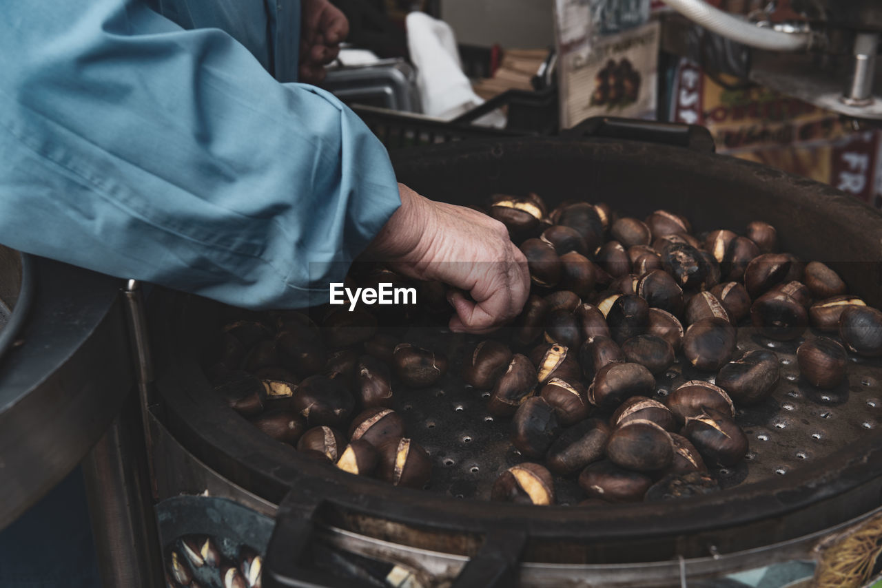 MAN PREPARING FOOD IN KITCHEN