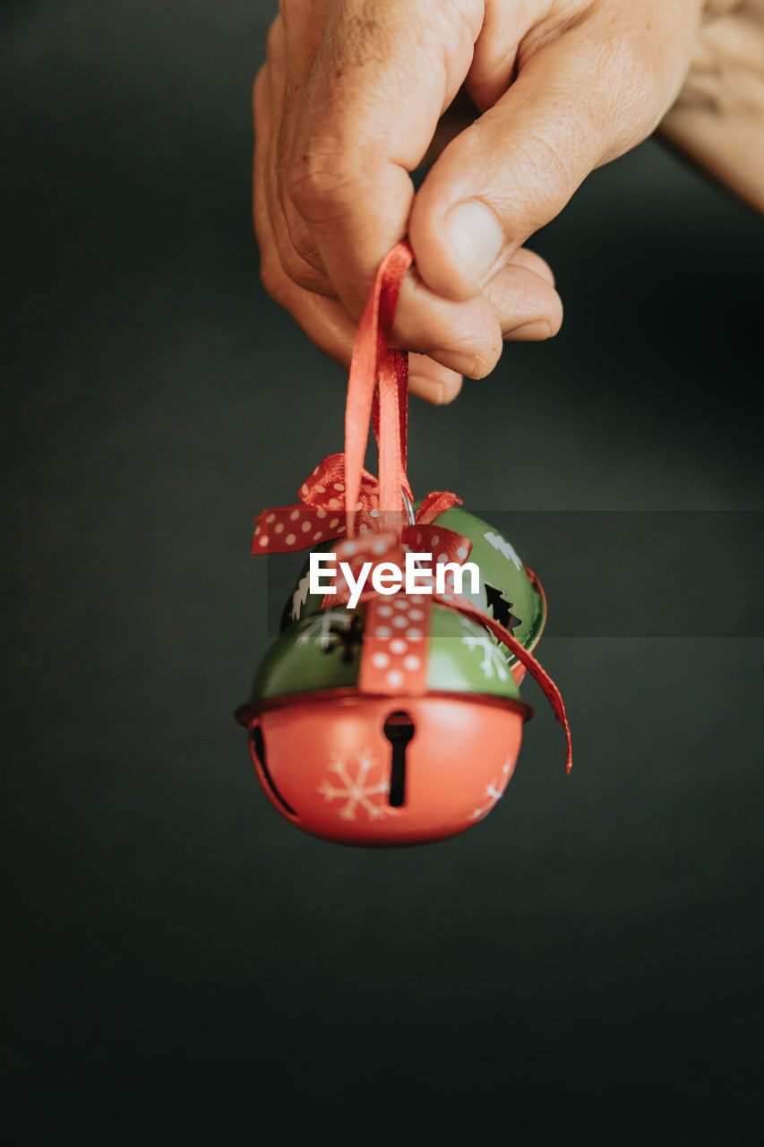 Cropped hand of woman holding christmas decoration