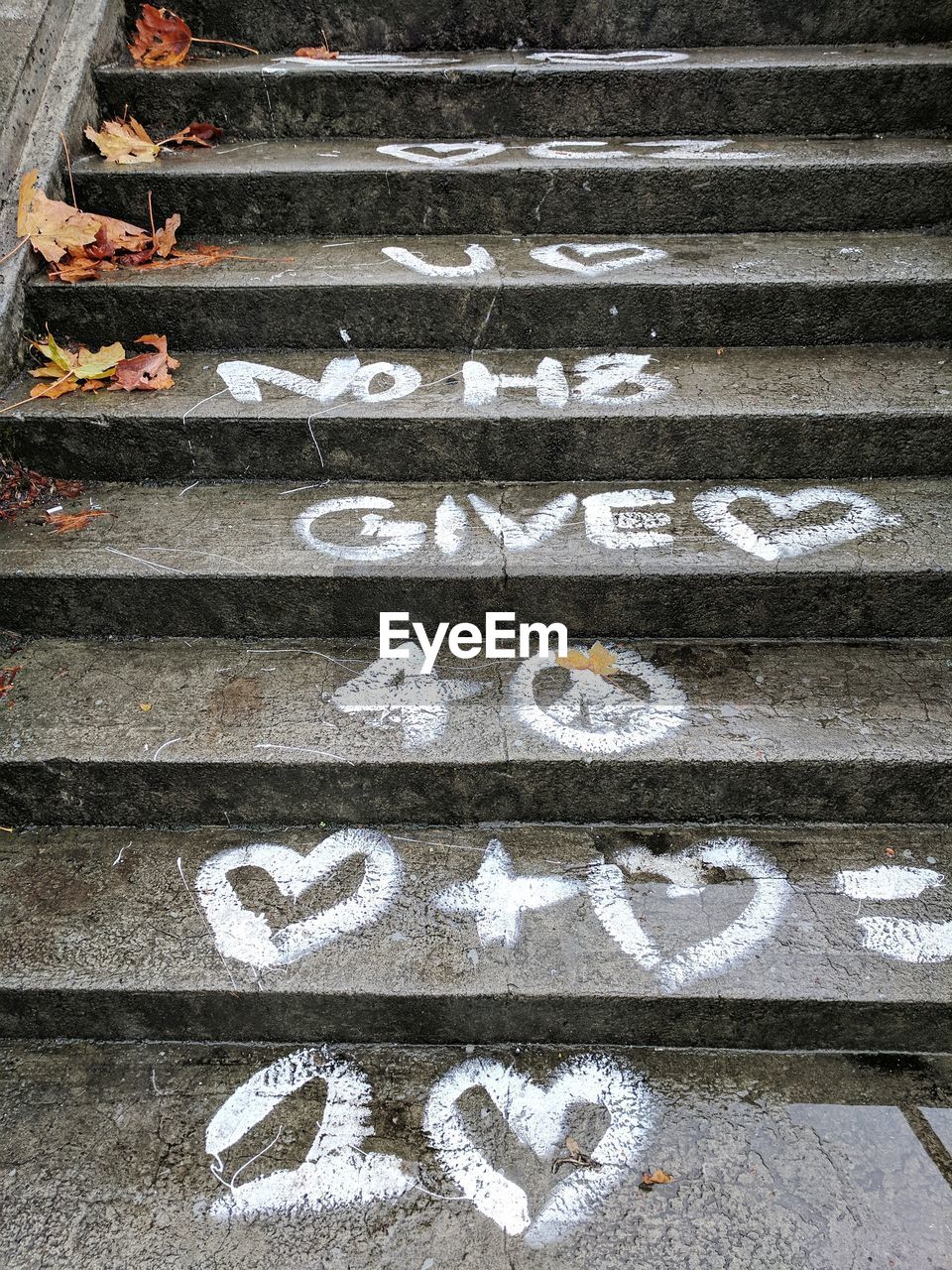 HIGH ANGLE VIEW OF TEXT ON PAVING STONE