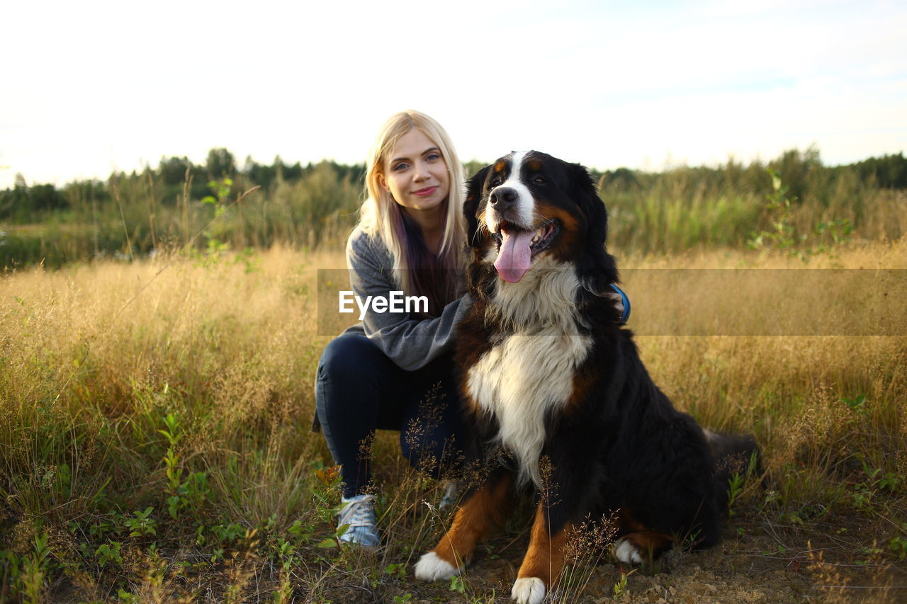 Woman with dog on field