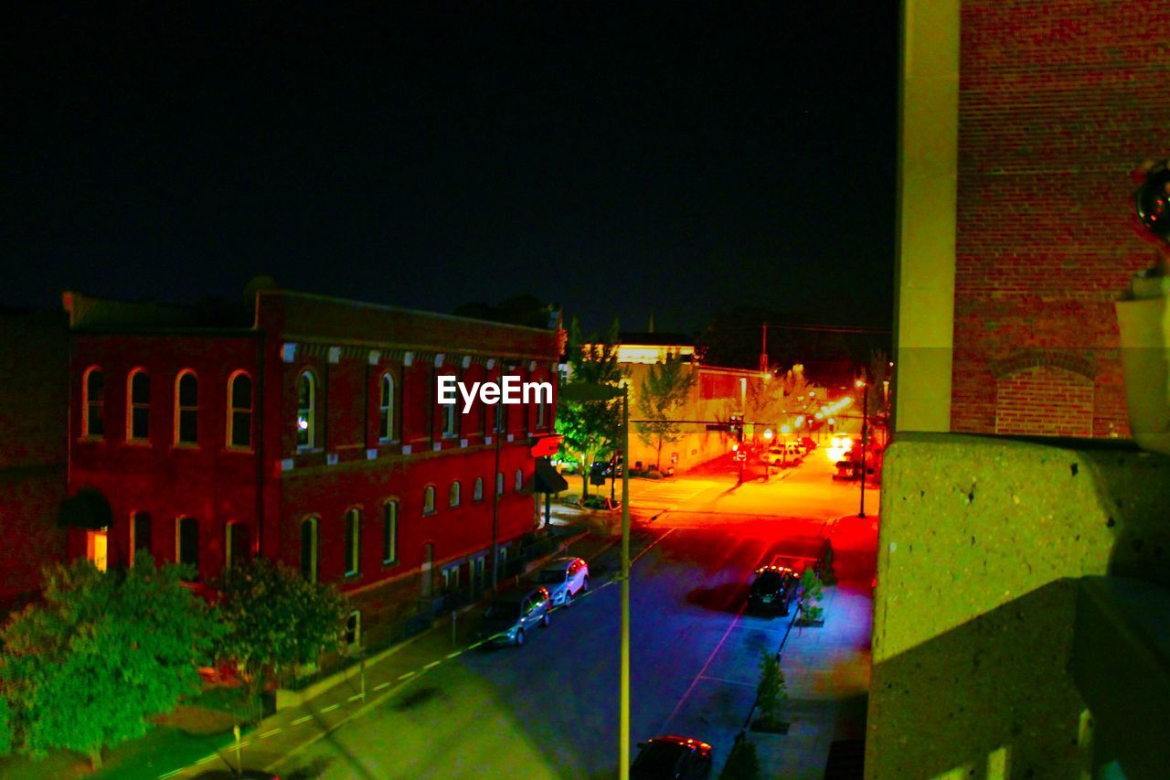 VIEW OF ILLUMINATED CITY AT NIGHT