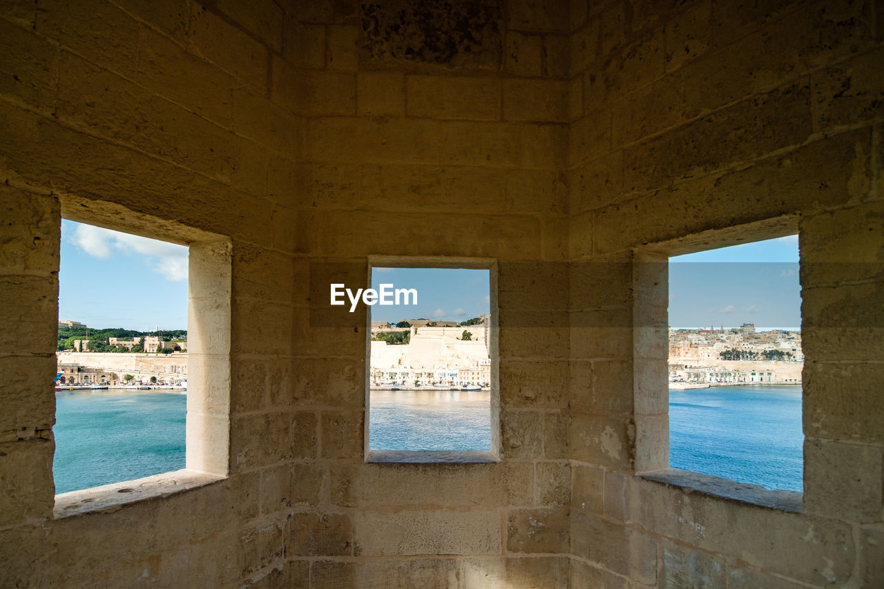 water, architecture, sea, sky, built structure, nature, travel destinations, travel, day, wall, history, window, no people, beach, land, ancient history, house, tourism, the past, outdoors, horizon, estate, blue, scenics - nature, old, horizon over water, cloud, building