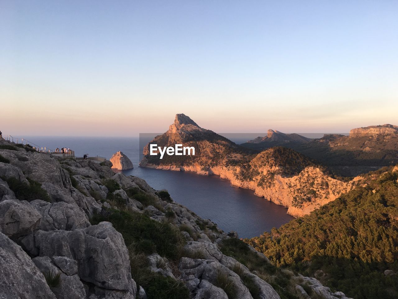 Scenic view of sea and mountains against clear sky