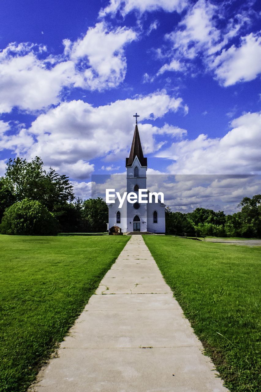 Facade of church against cloudy sky