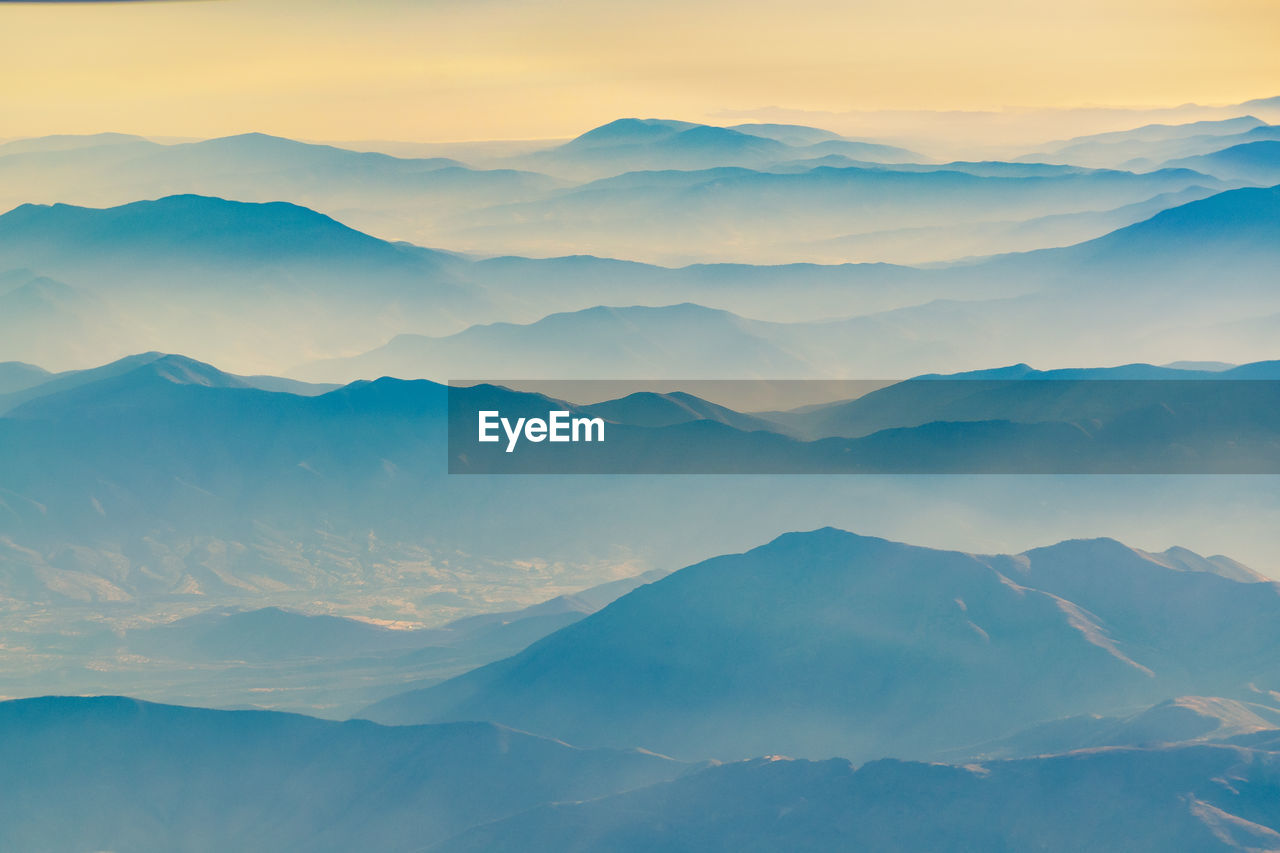 Scenic view of mountain range against sky during sunset