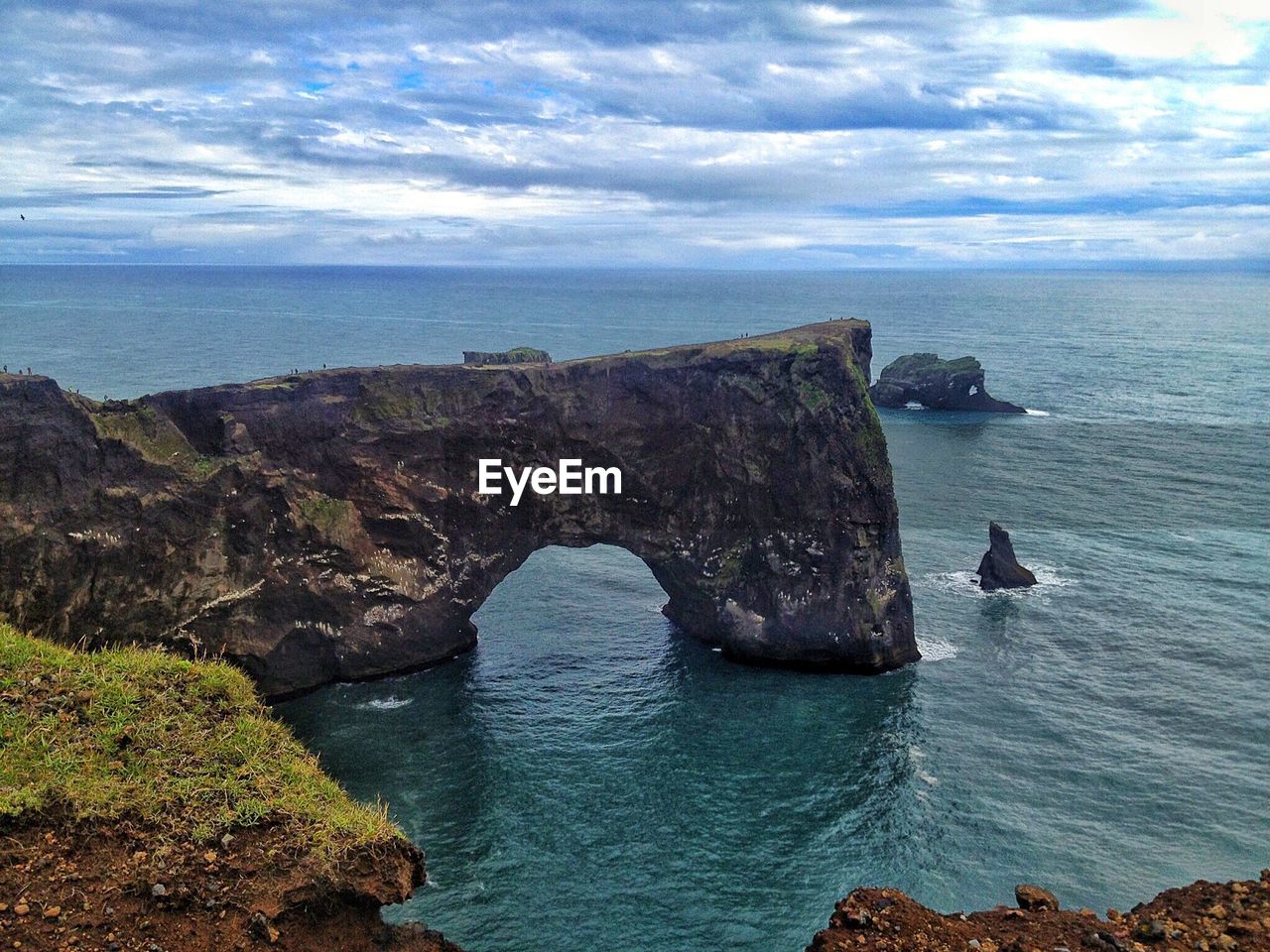 Scenic view of sea against cloudy sky