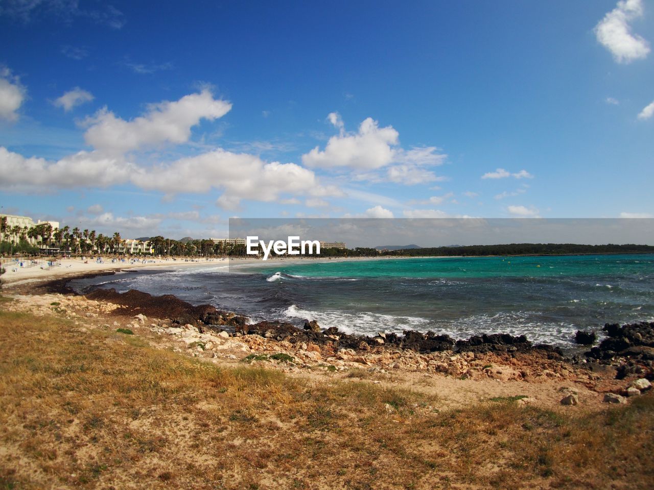 Scenic view of beach by sea against sky