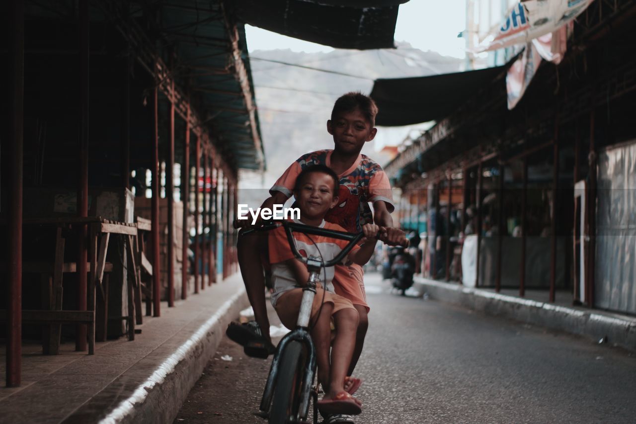 Portrait of man riding bicycle on city