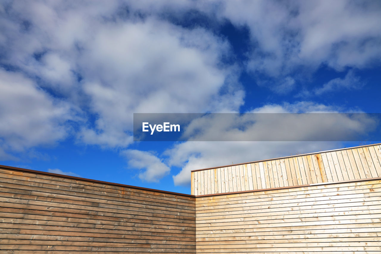 Low angle view of building against cloudy sky