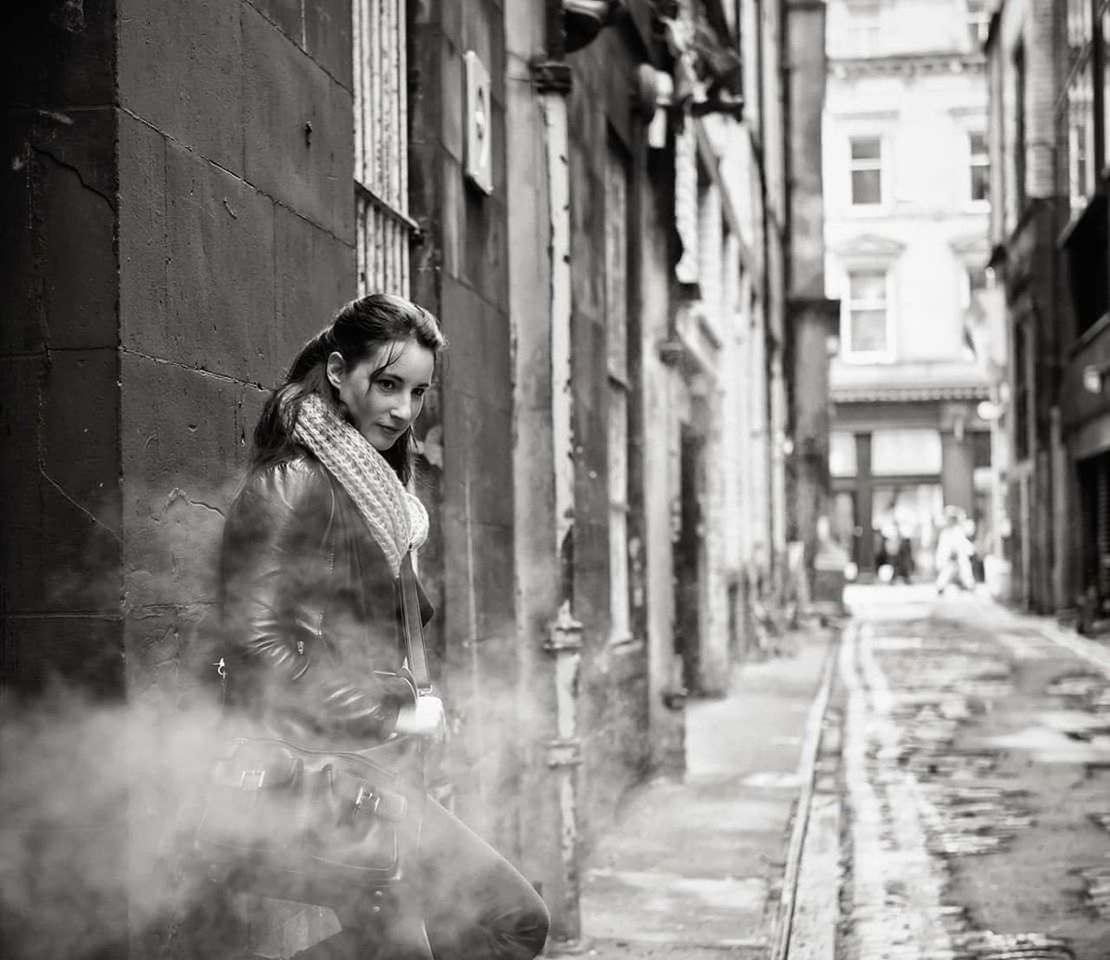 WOMAN WALKING ON CITY STREET