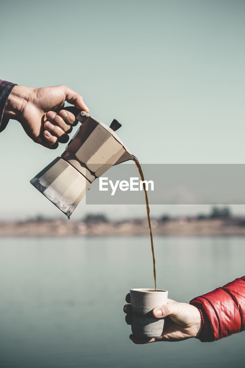 Hand holding coffee cup