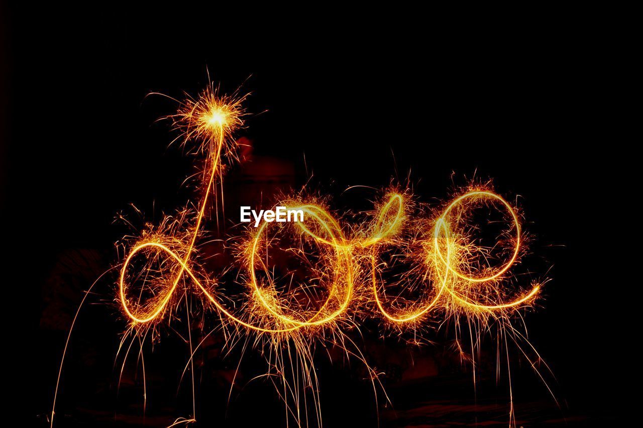 Love text made with firework display against black background