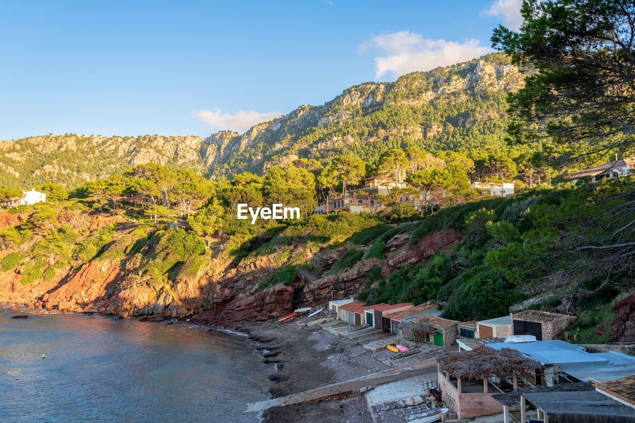 Scenic view of river by mountain against sky