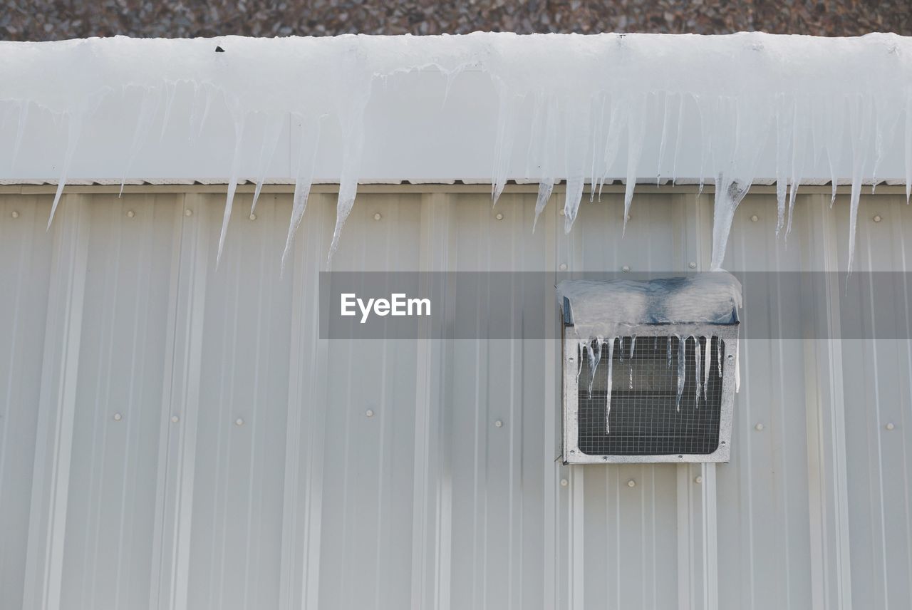 Icicles on building and window