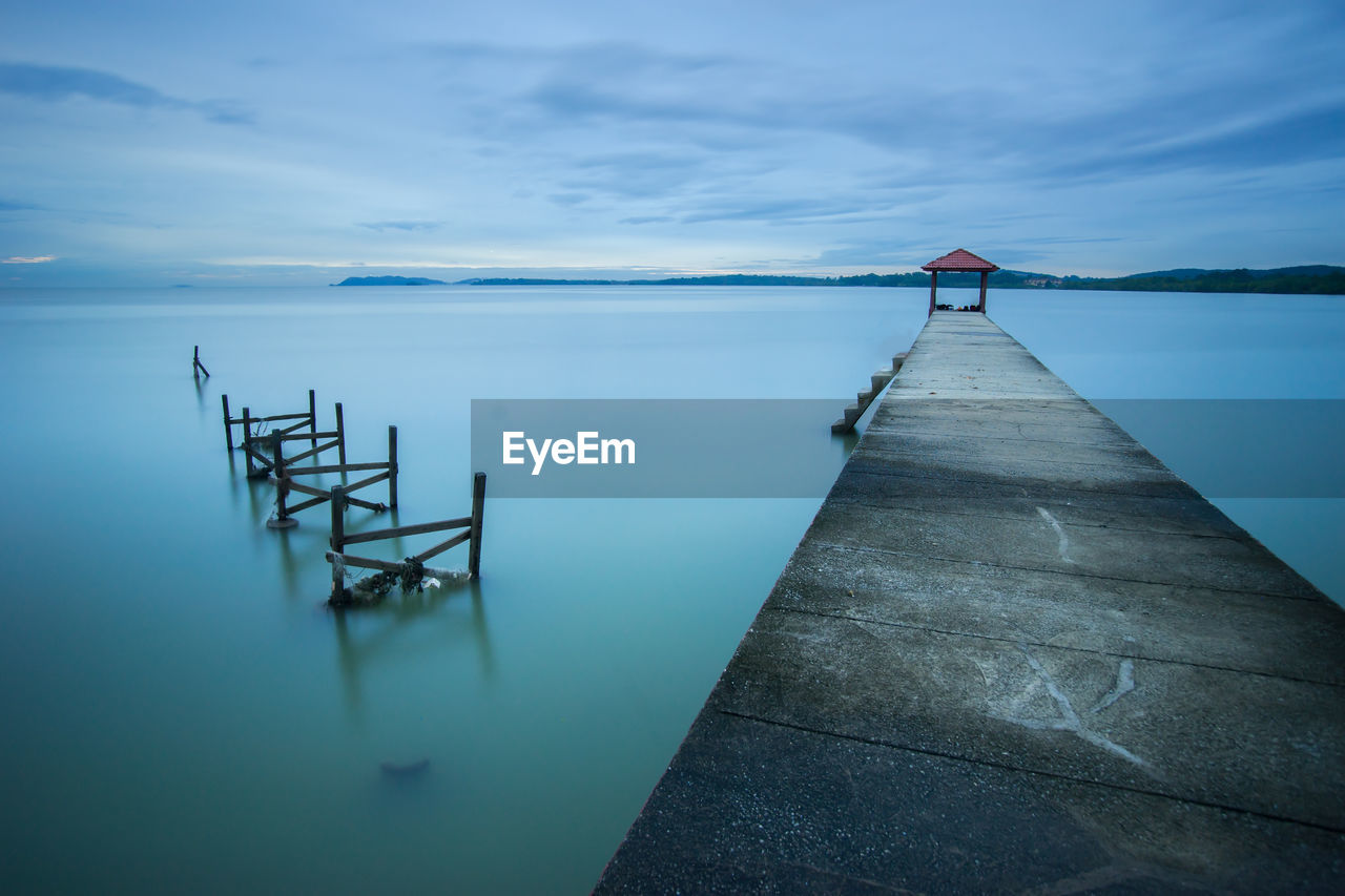 Pier over sea against sky