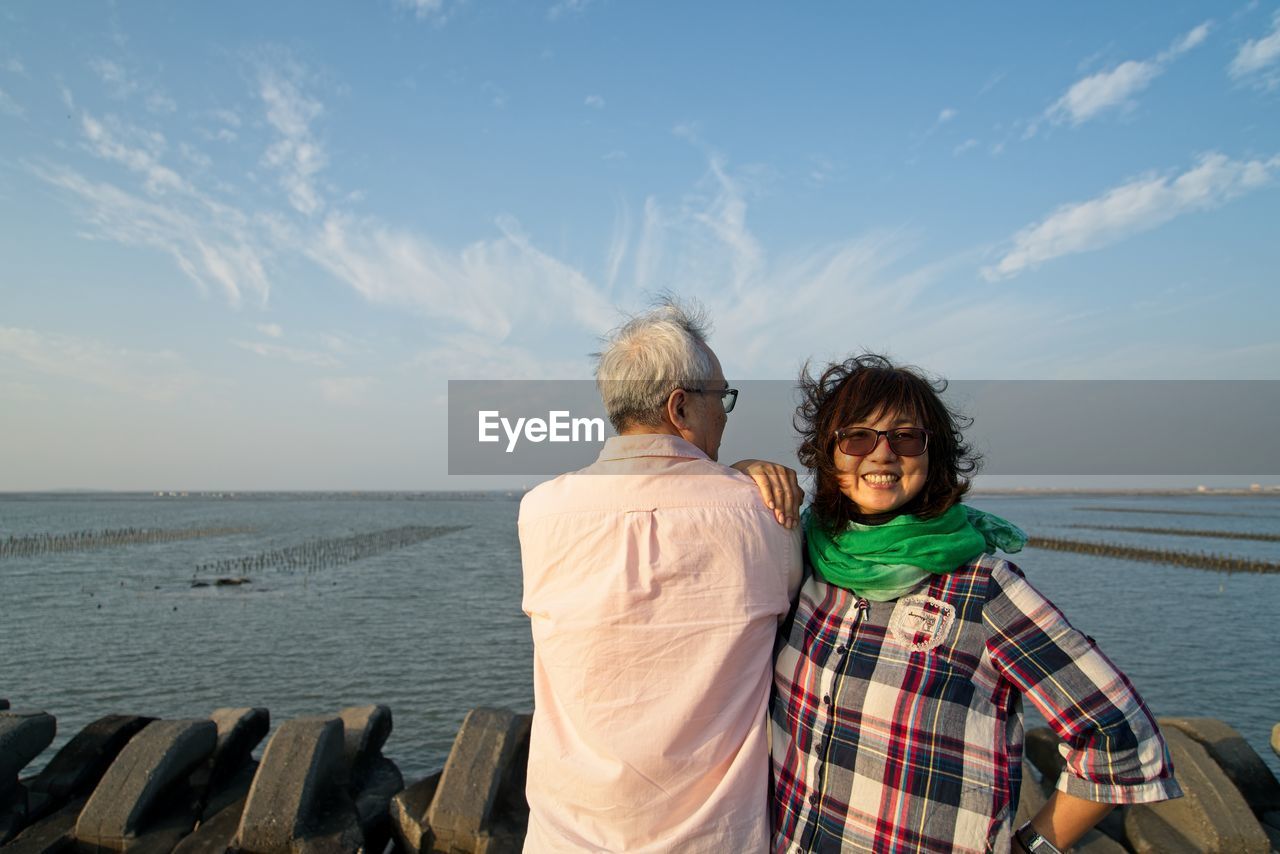 FRIENDS ON SEA AGAINST SKY