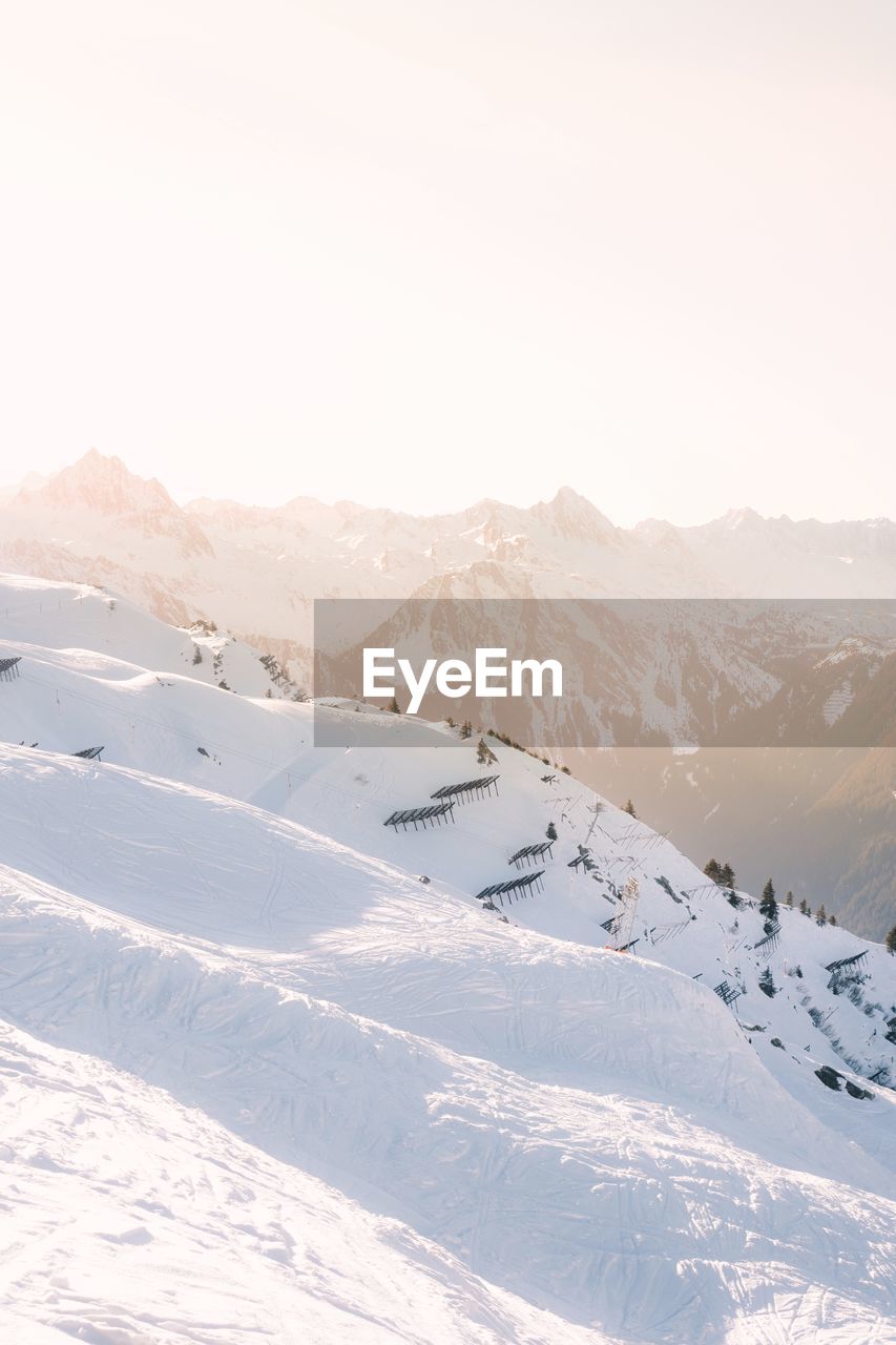 Scenic view of snow covered mountains against sky