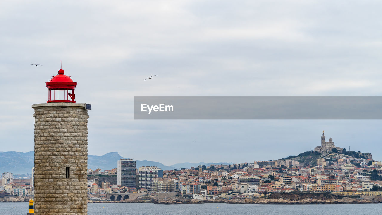 The lighthouse at the chateau d'if overlooking the bay of marseille in a cloudy day, france