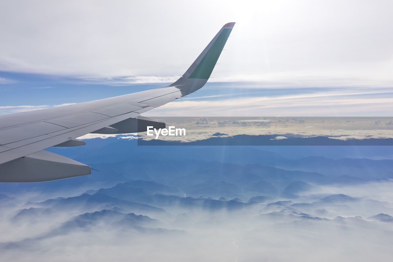 Aerial view of cloudscape over airplane wing