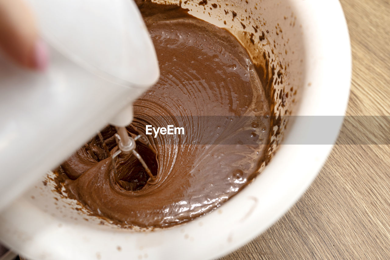 Mixing the dough with a hand mixer with a whisk with melted butter added, the dough is thick  mass.