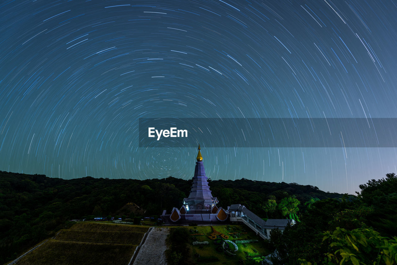 Temple against star trails at night