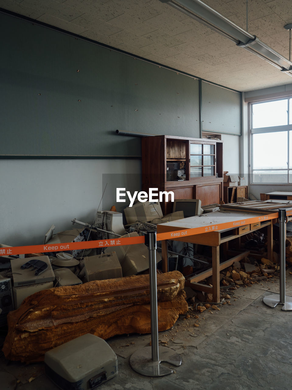 EMPTY CHAIRS AND TABLE IN ABANDONED ROOM