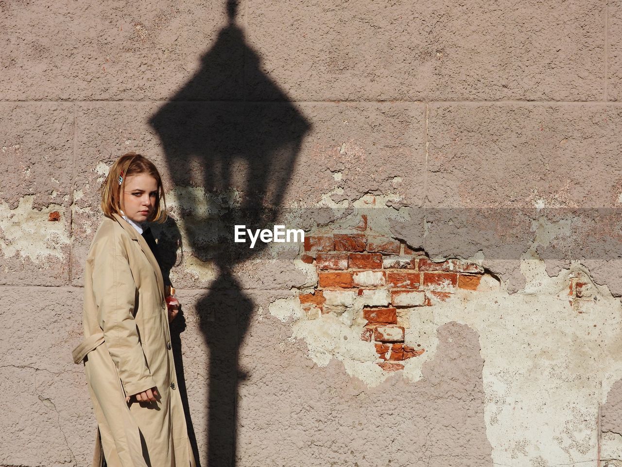 Woman standing against wall