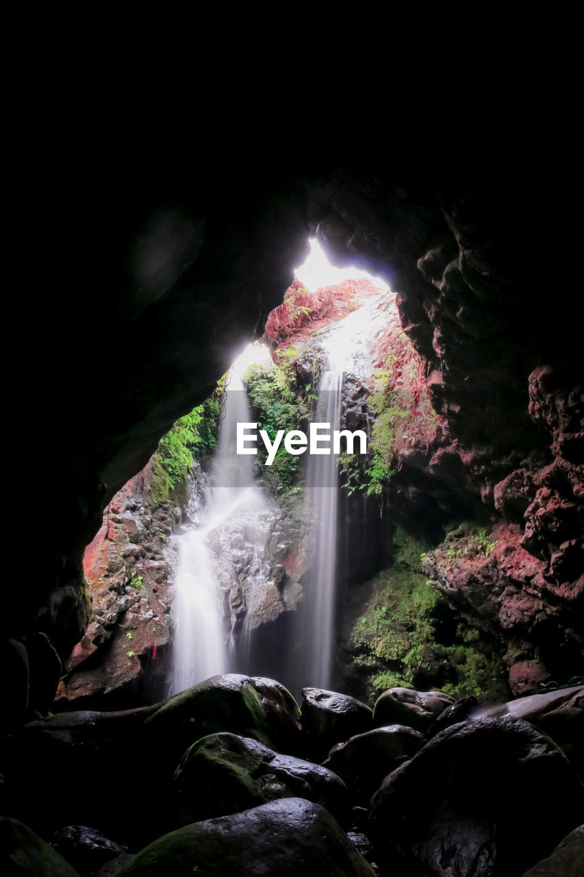 LOW ANGLE VIEW OF WATERFALL ON ROCK FORMATION