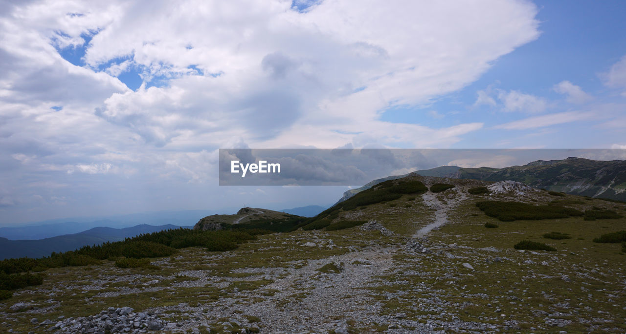 SCENIC VIEW OF LANDSCAPE AND MOUNTAINS AGAINST SKY