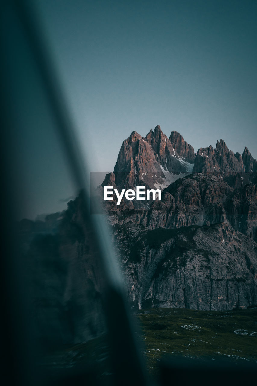 Scenic view of rock formation in sea against sky