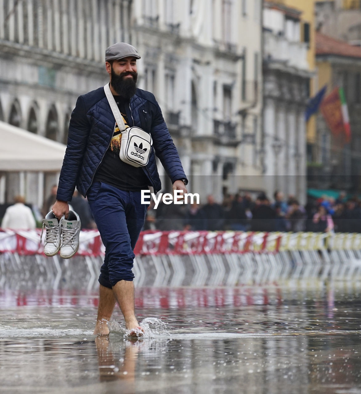 FULL LENGTH OF MAN WITH UMBRELLA IN CITY