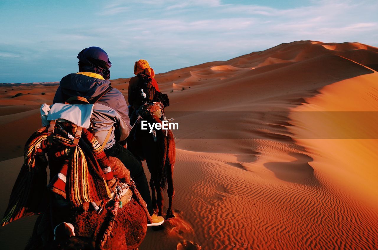 Rear view of people in desert